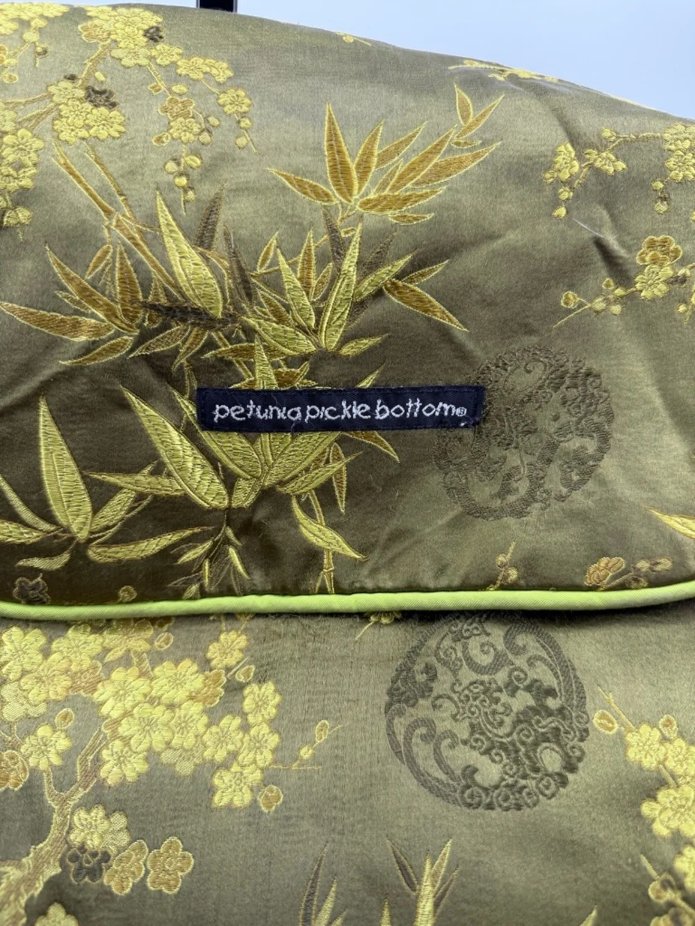 Petunia Pickle Bottom diaper bag in a green, silky, bamboo-themed fabric